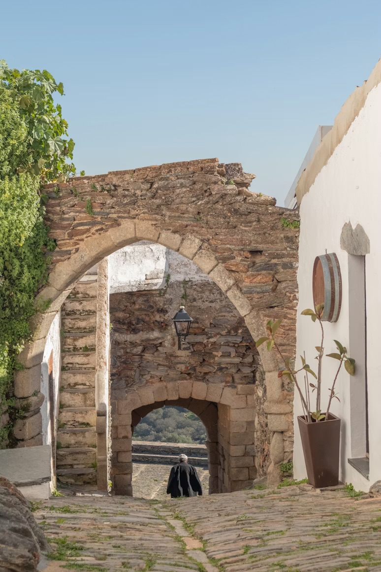 A stone archway in a whitewashed Alentejo heritage village